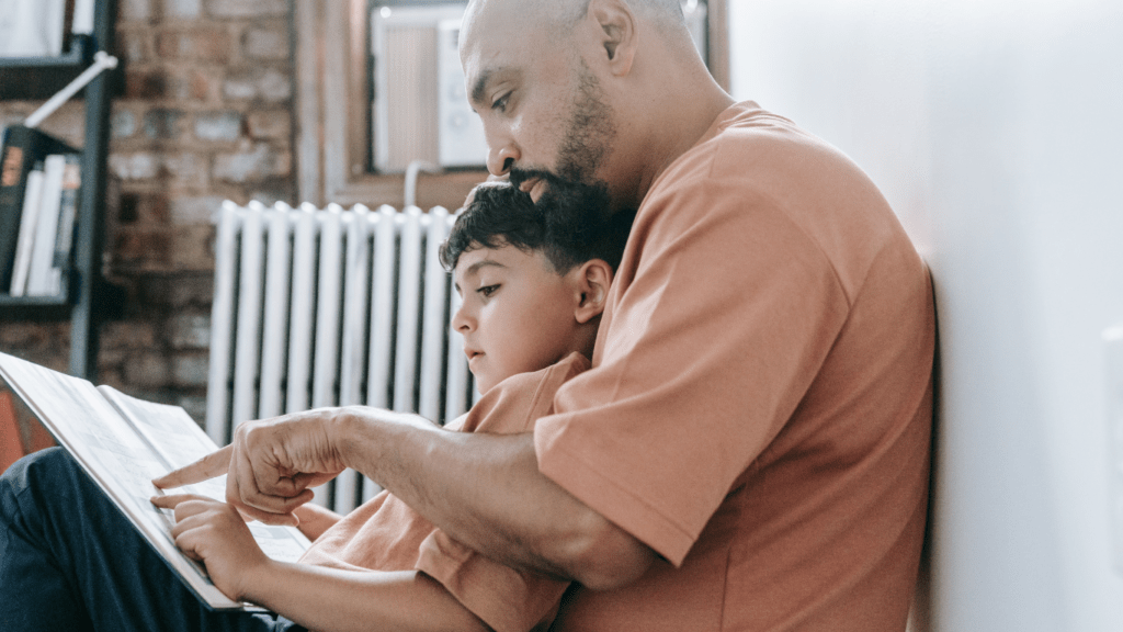 a parent and child are reading a book together