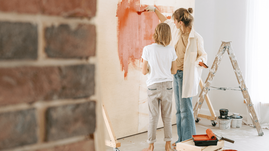 A woman and a child at a table painting