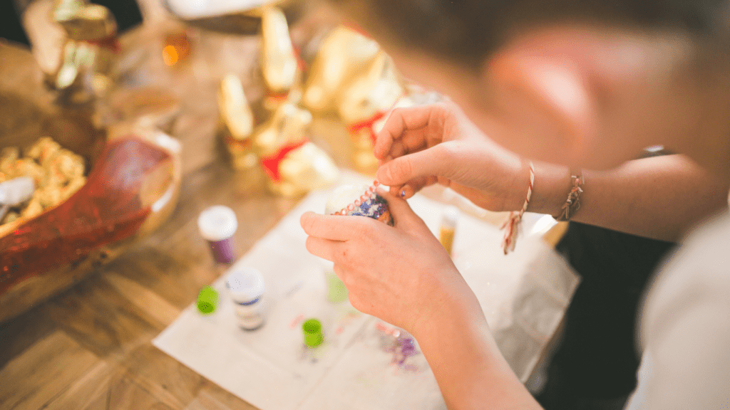 a person is working on a craft at a table