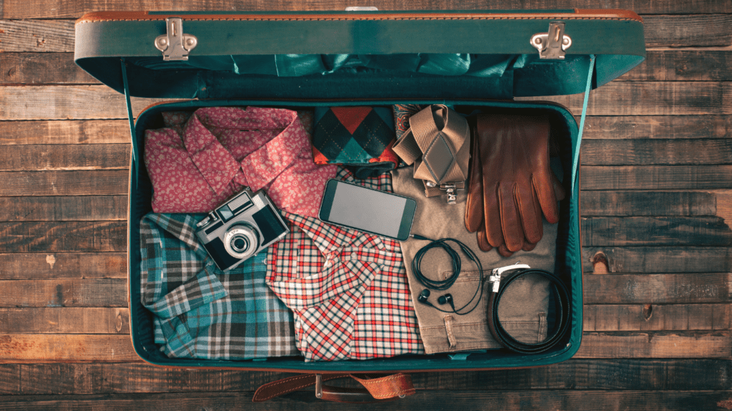 an open suitcase filled with clothing and accessories