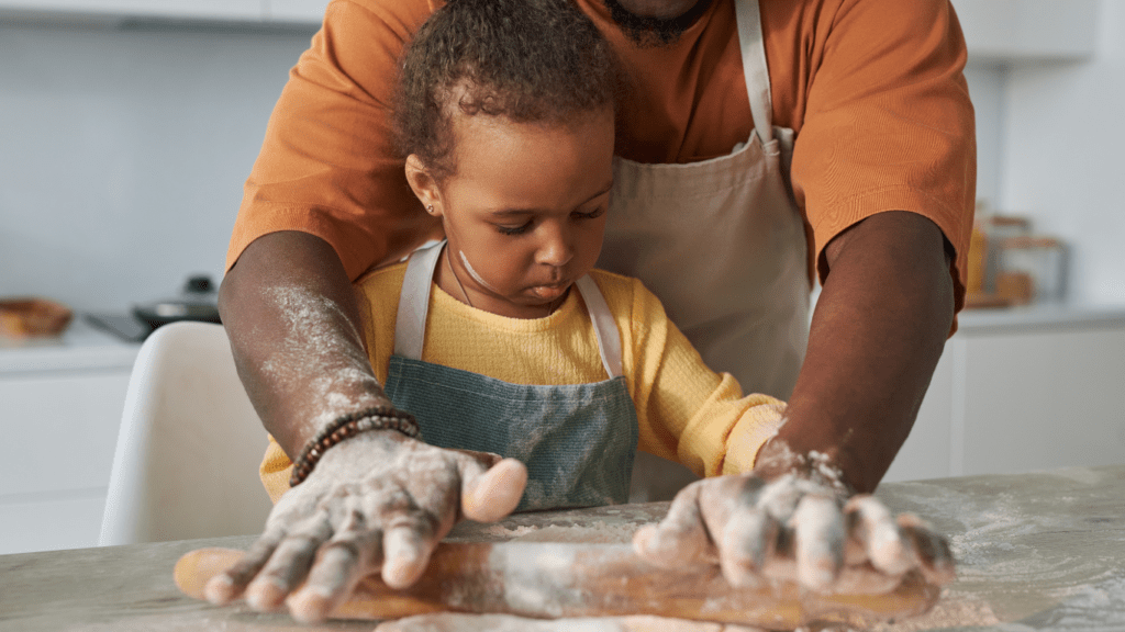 A father and daughter baking bread together