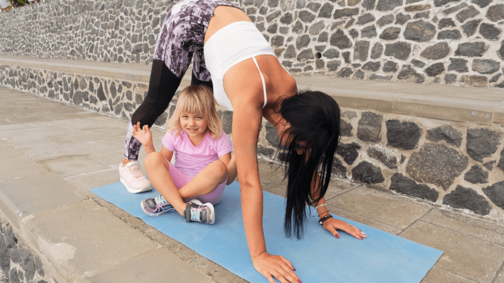 Two individuals doing yoga on a mat