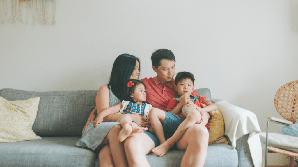 a family sitting on a couch in their living room