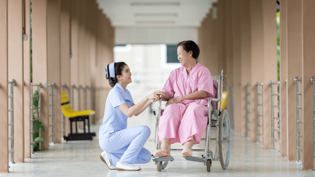 A person in wheelchair talking to nurse