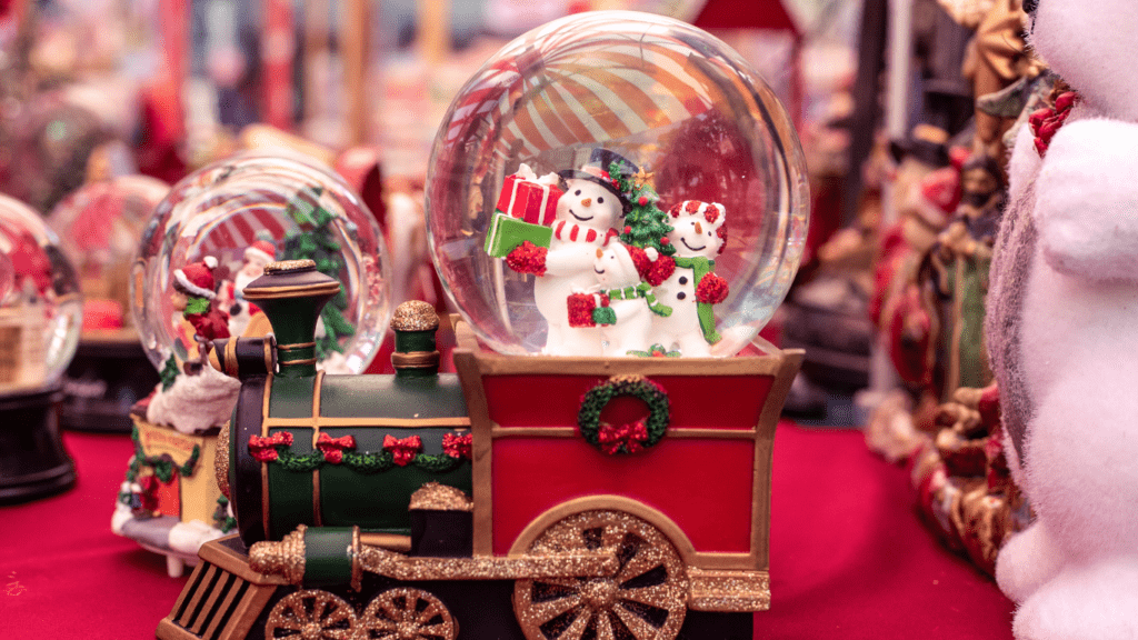 a christmas decoration with oranges, candles and a santa claus figurine