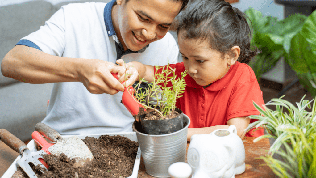 a person and a child are planting a plant in a pot