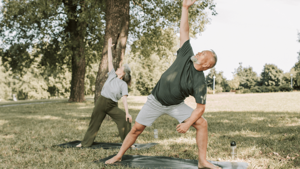 Two individuals doing yoga on a mat