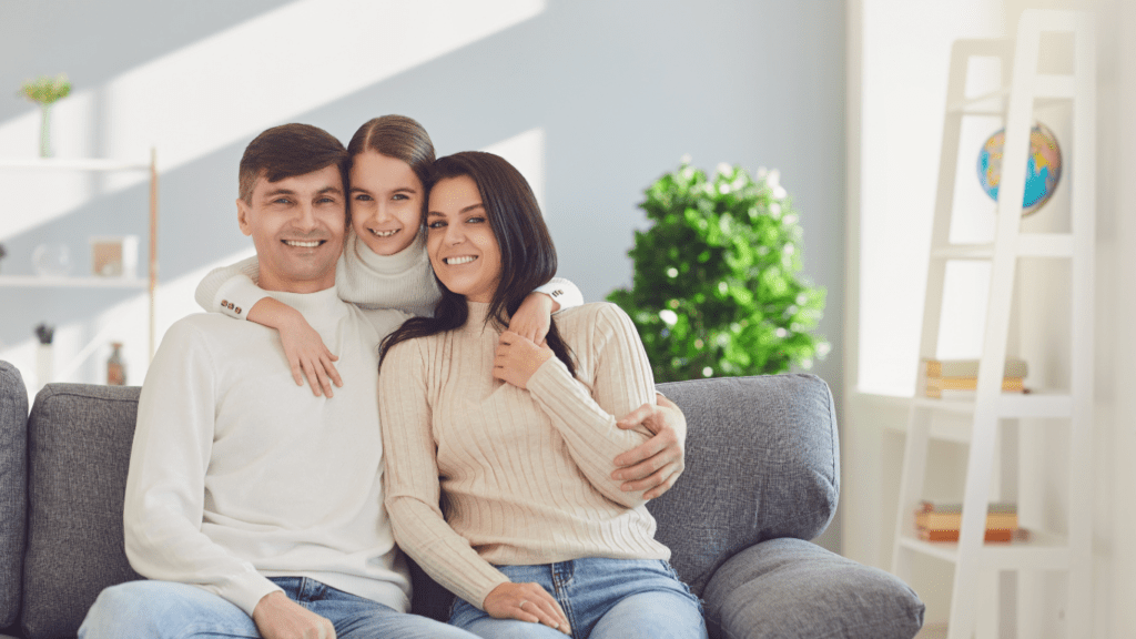 a family sitting on a couch in their living room