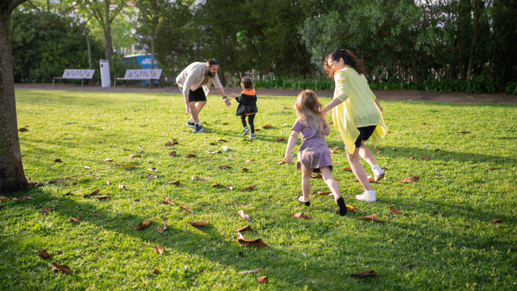 a group of children running in the park