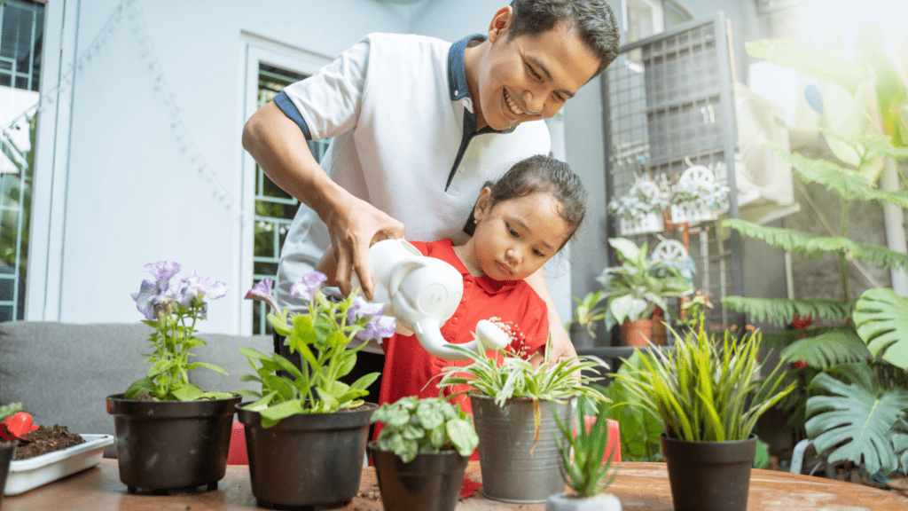 a person and a child are planting a plant in a pot