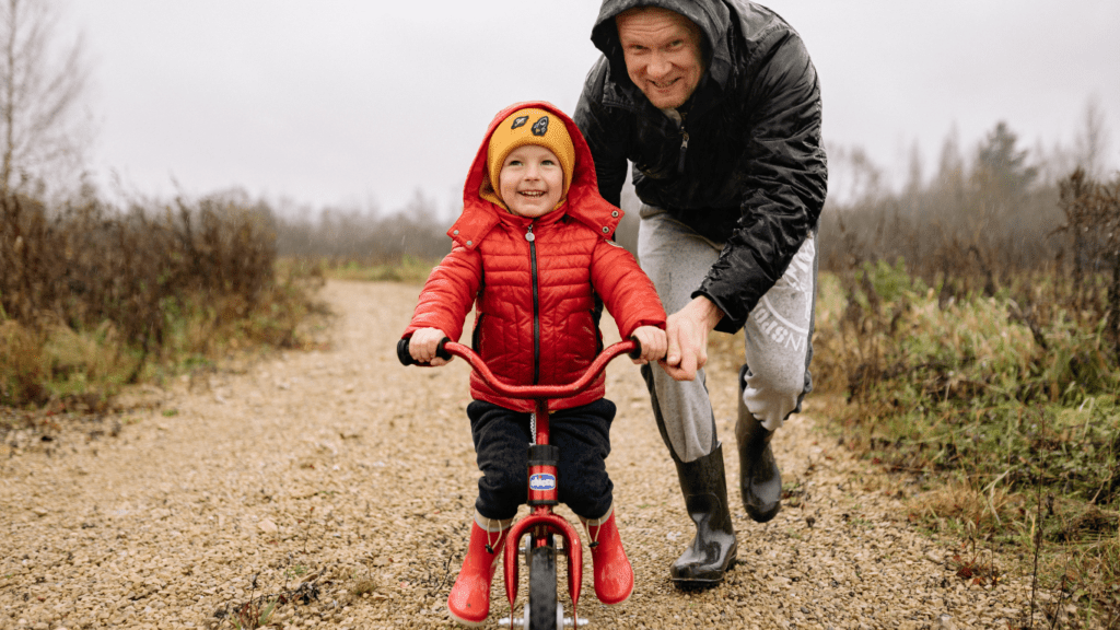 a person and a child riding a bike