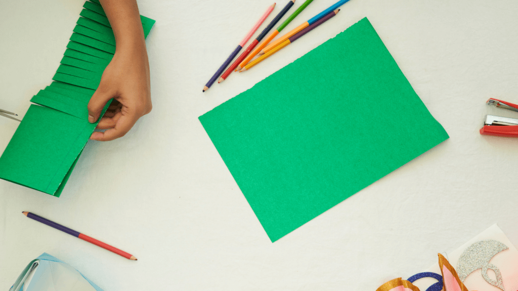 a person is working on a craft at a table