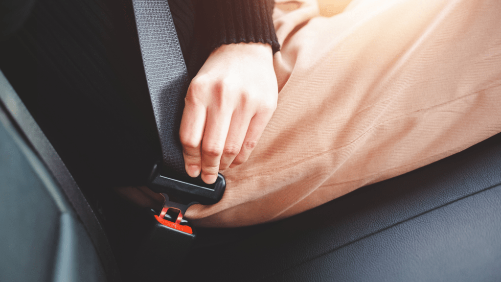 a person sitting in a car with a seat belt on