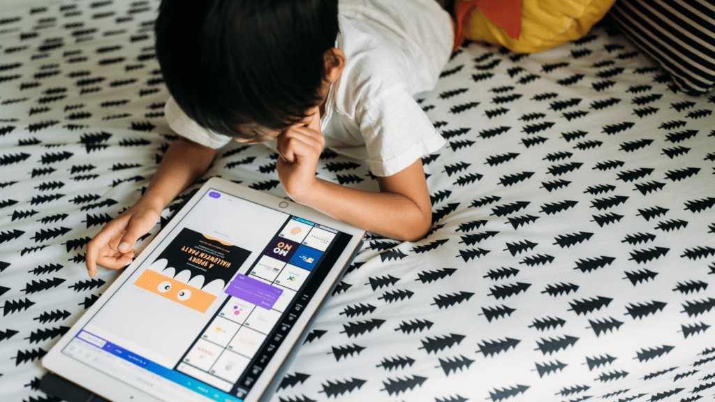 a person sitting on a bed using an ipad