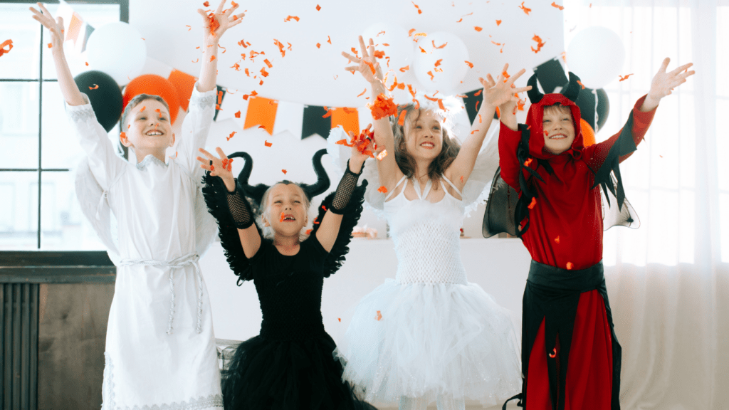 children in devil costumes posing for a photo