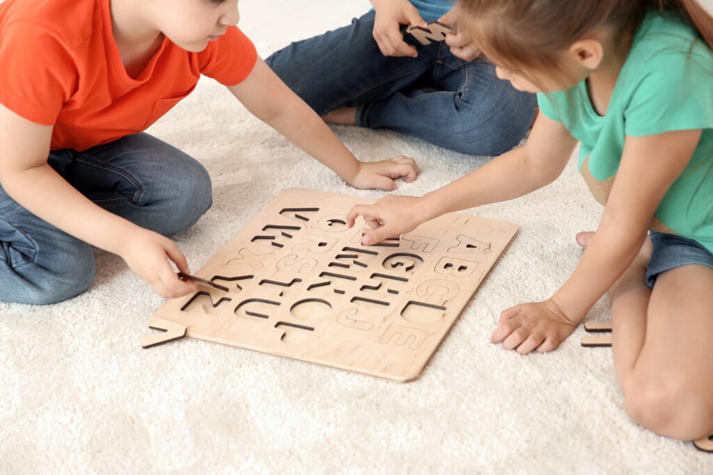 children learning alphabet playing with wooden puz 2026 03 27 02 15 58 utc1
