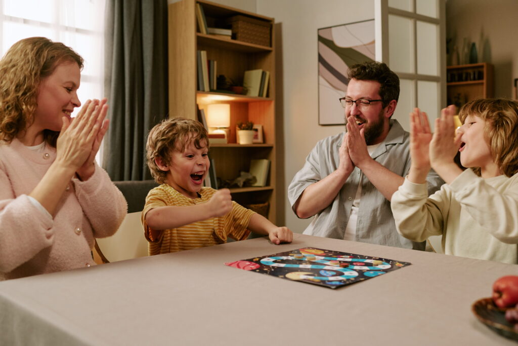 happy family cheering while playing board game at 2026 06 23 15 30 36 utc1